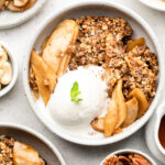 Paleo Apple Crisp in a white owl with ice cream and mint
