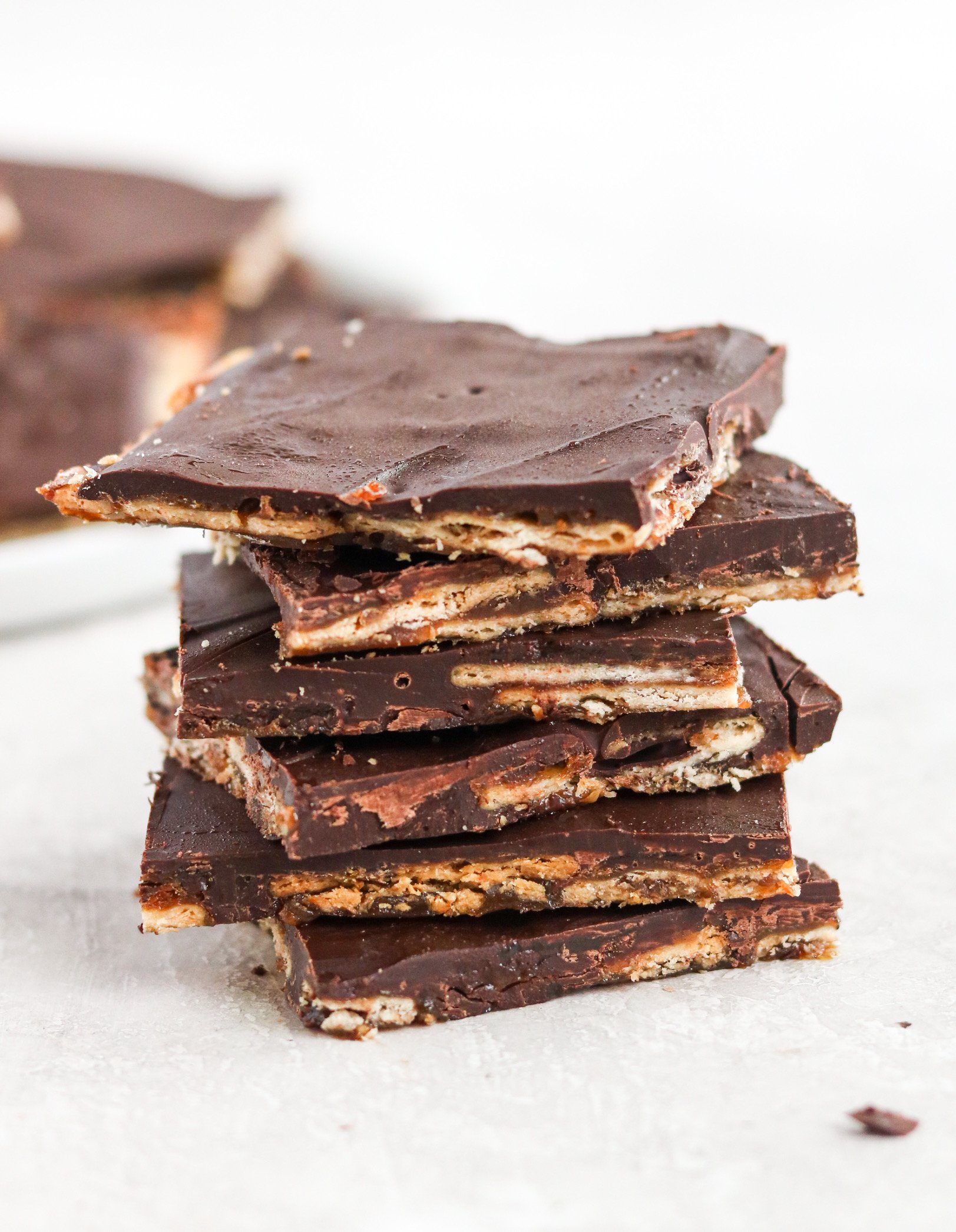 A stack of Christmas Crack dessert with crackers, chocolate and caramel