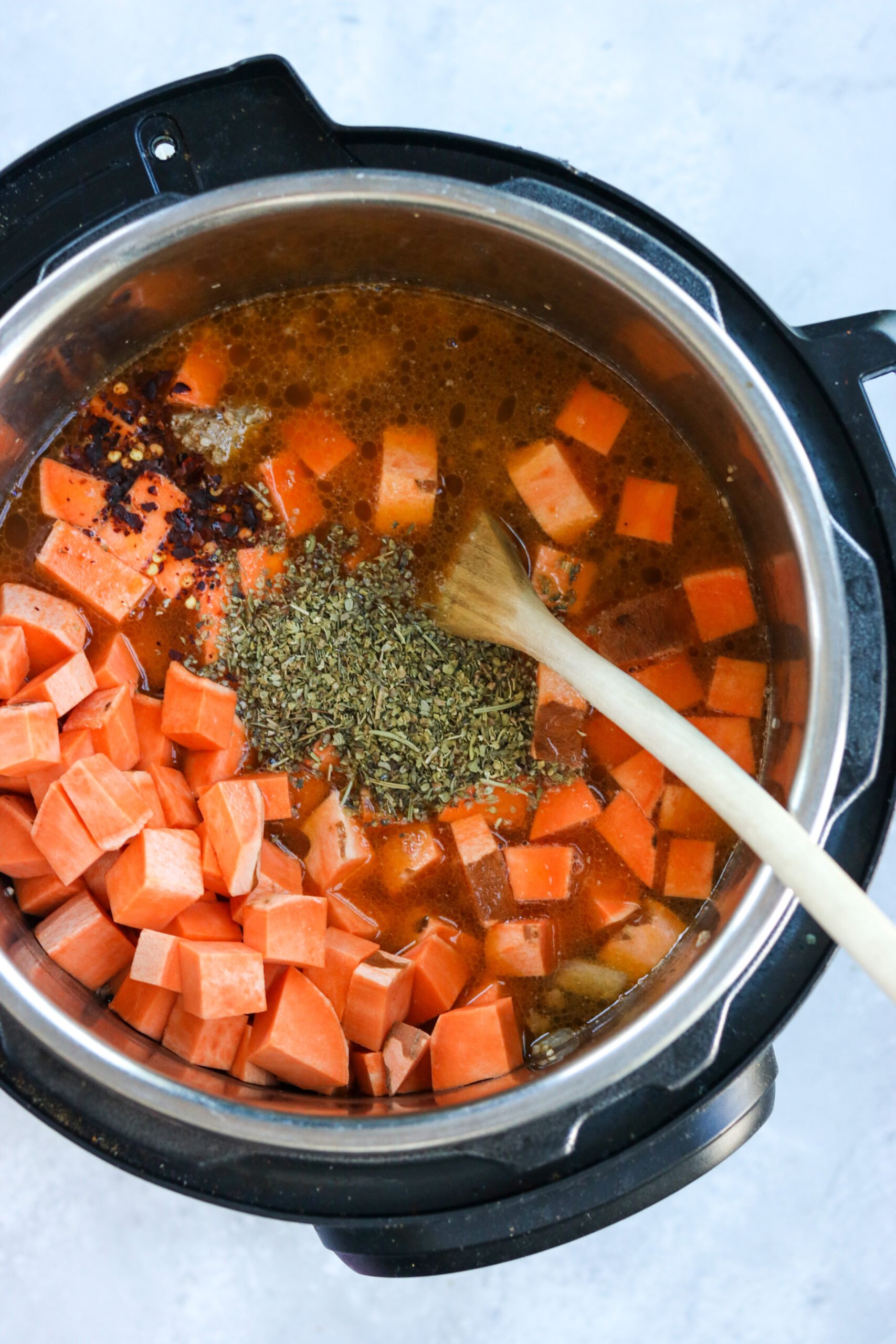 Sweet Potatoes being added to Zuppa Toscana in the Instant Pot
