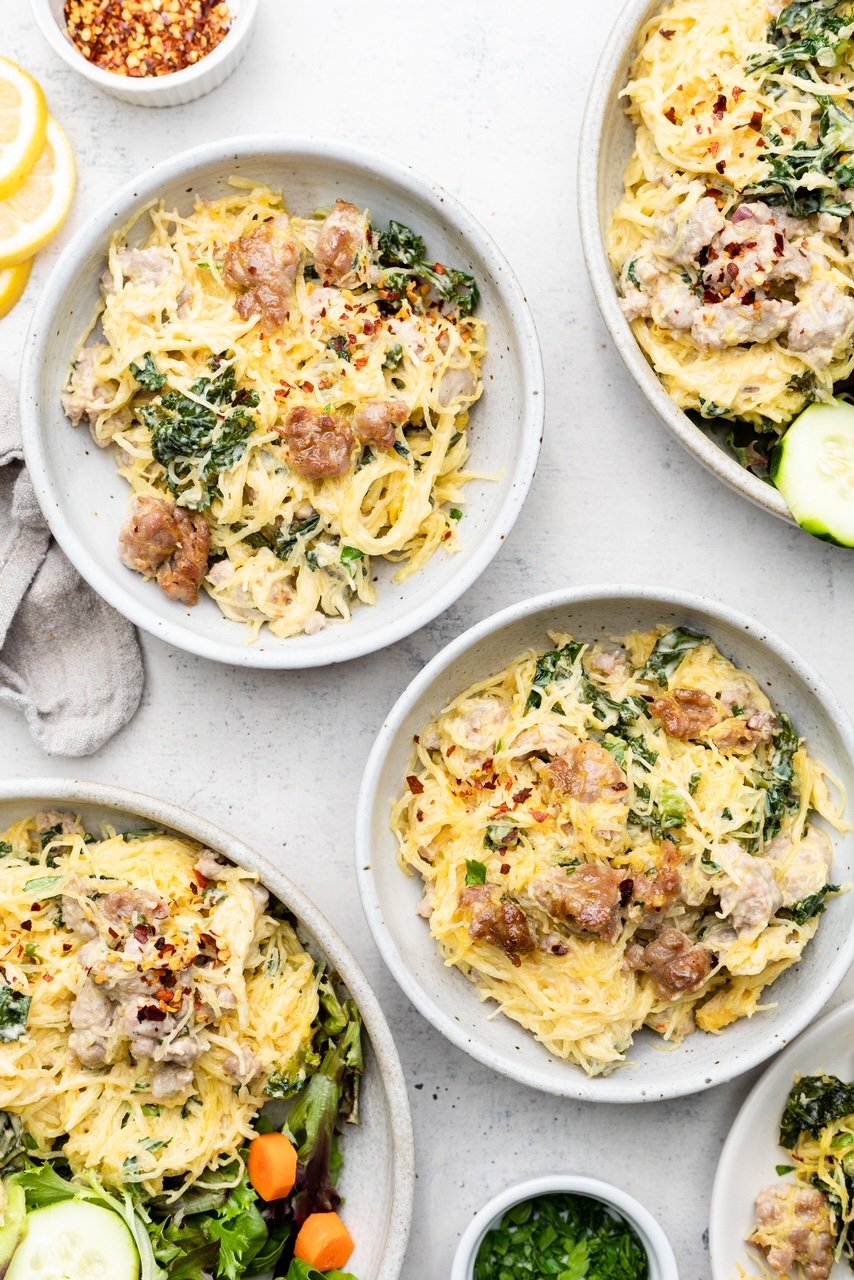 Two bowls of tuscan spaghetti squash casserole with sausage and kale