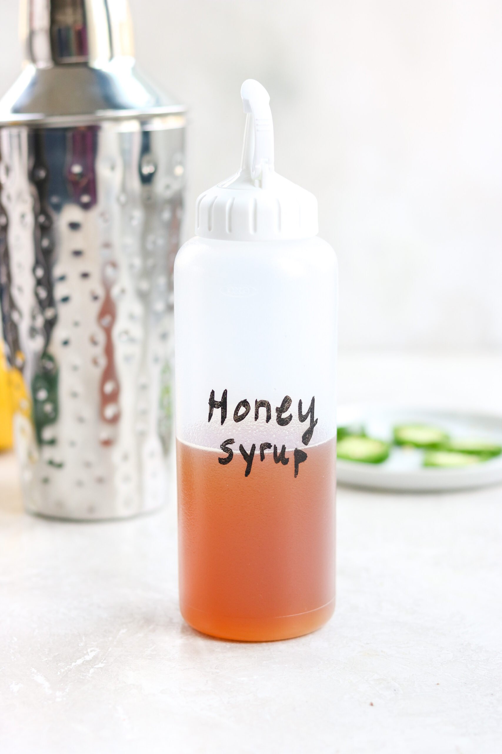 Honey Simple Syrup in a labeled plastic reusable squeeze bottle