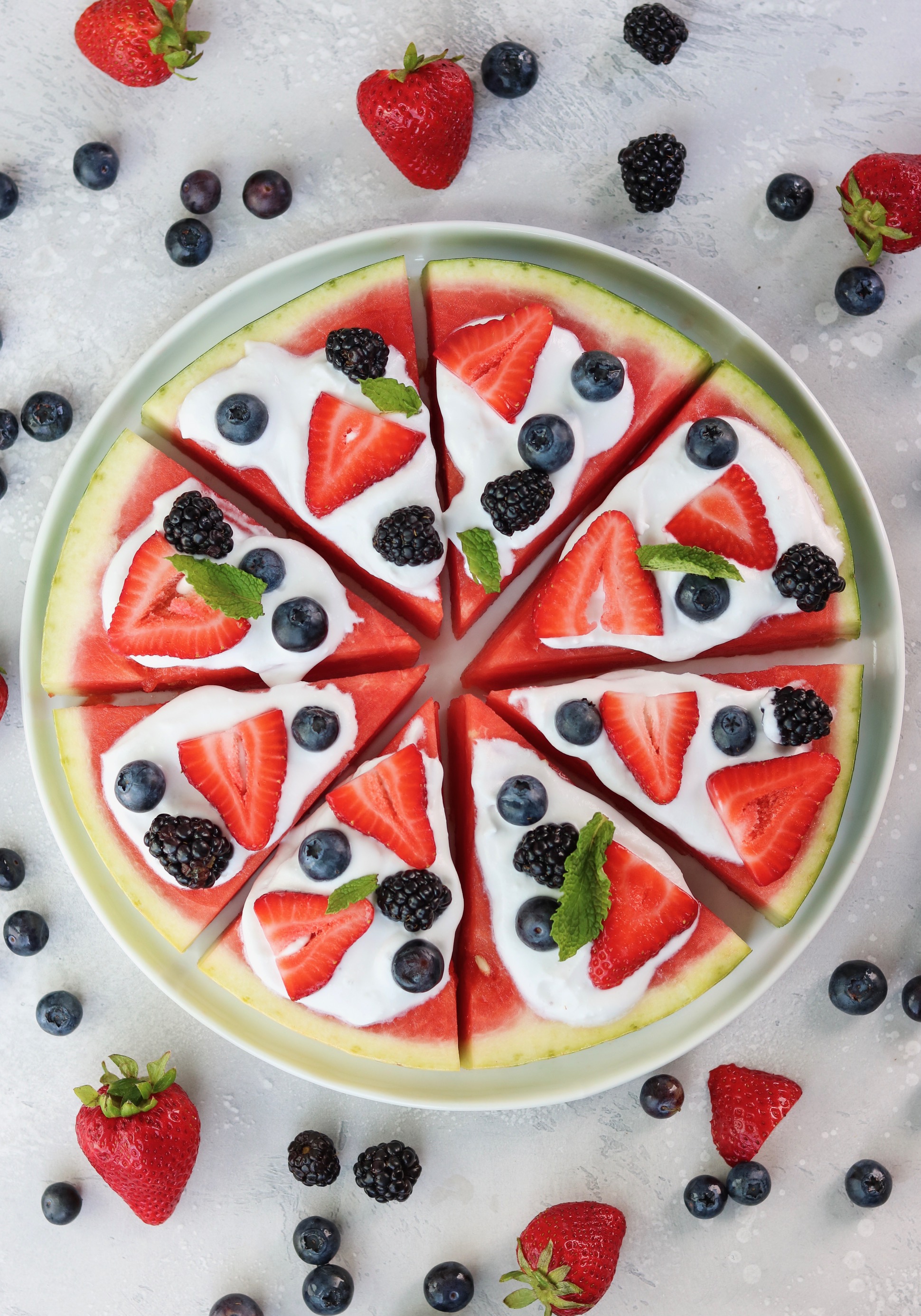 watermelon pizza with homemade coconut whipped cream and fresh berries