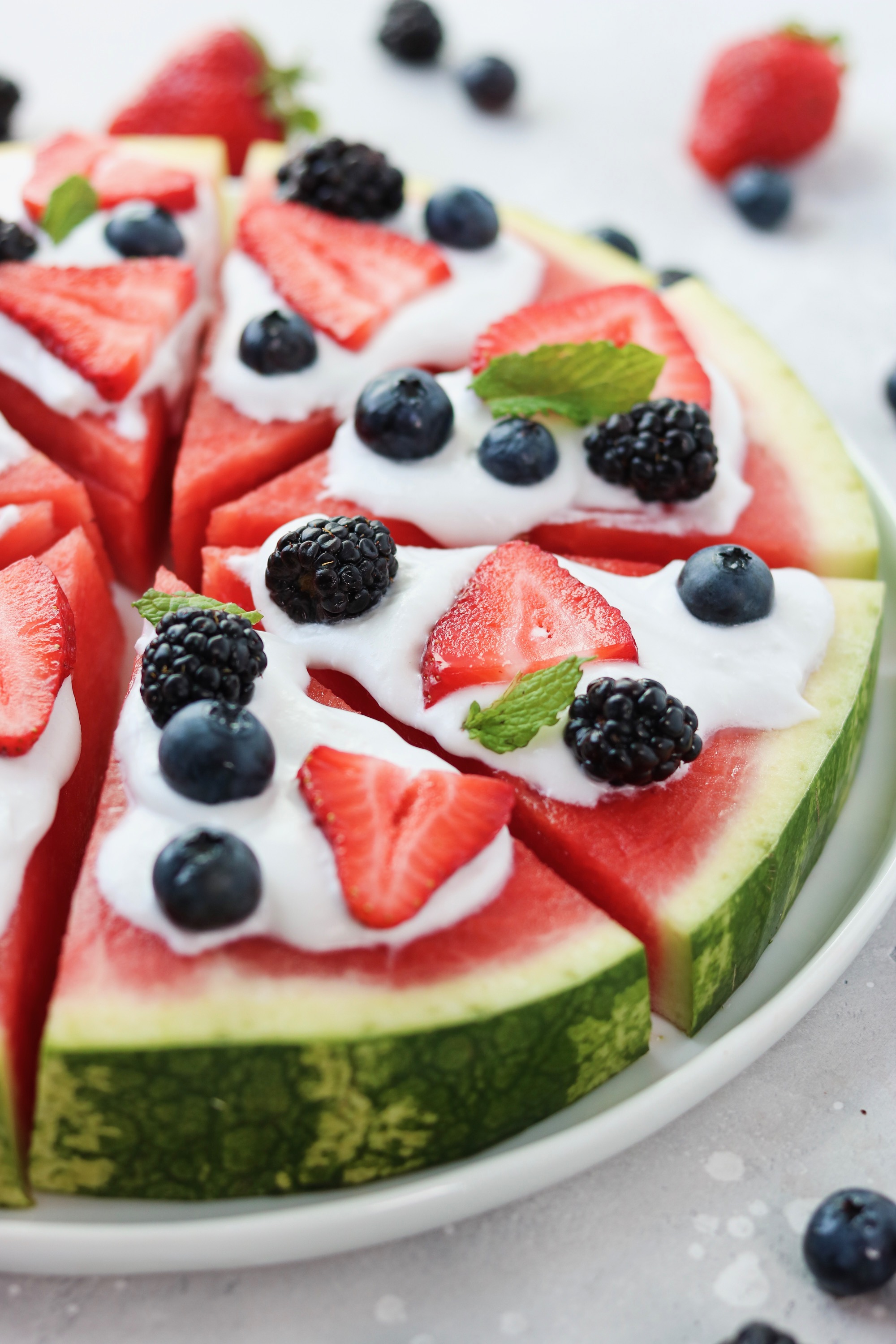 watermelon pizza with homemade whipped coconut cream and fresh berries