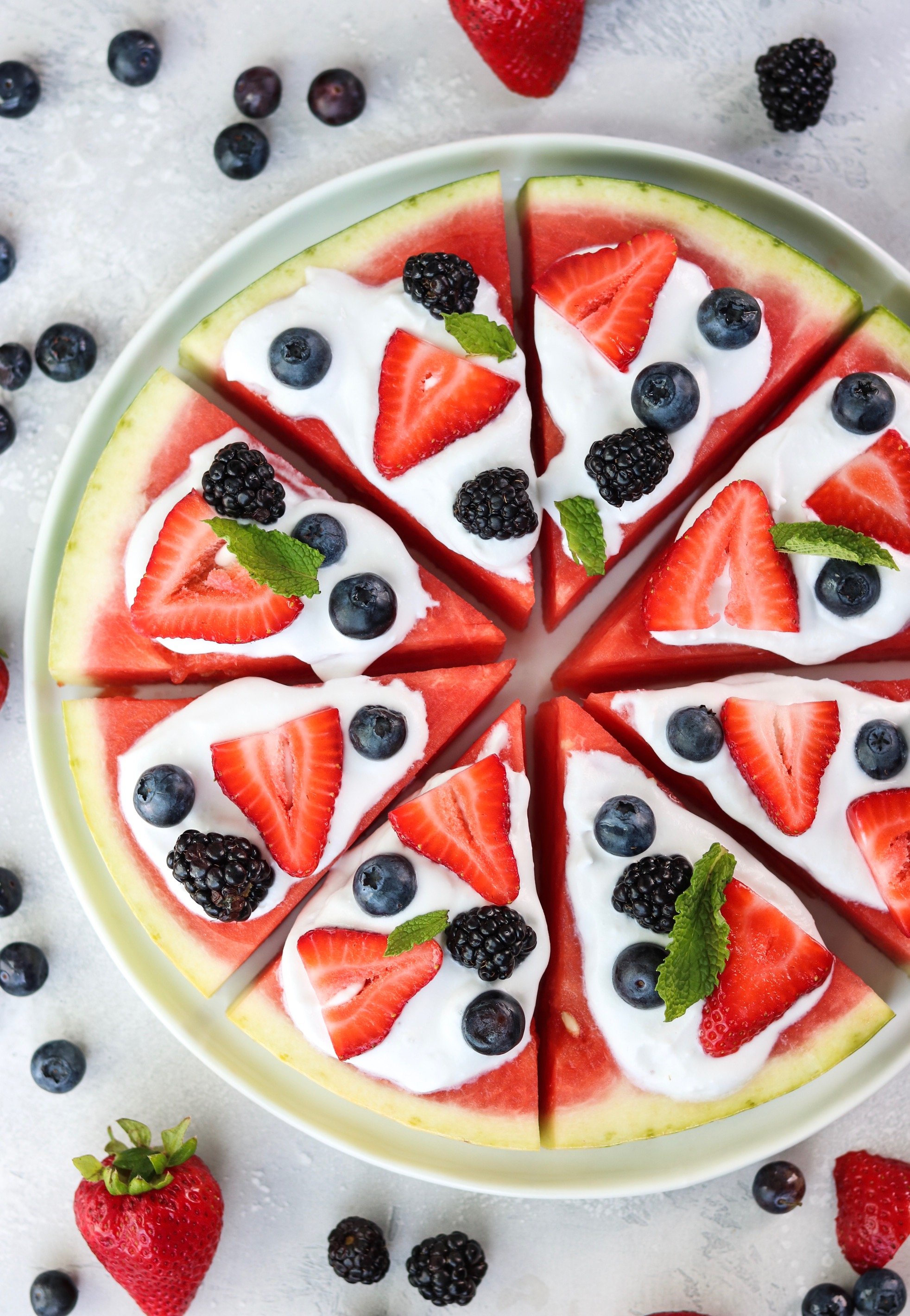 watermelon pizza with homemade coconut whipped cream and berries
