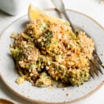 a serving of gluten free broccoli casserole on a white dish