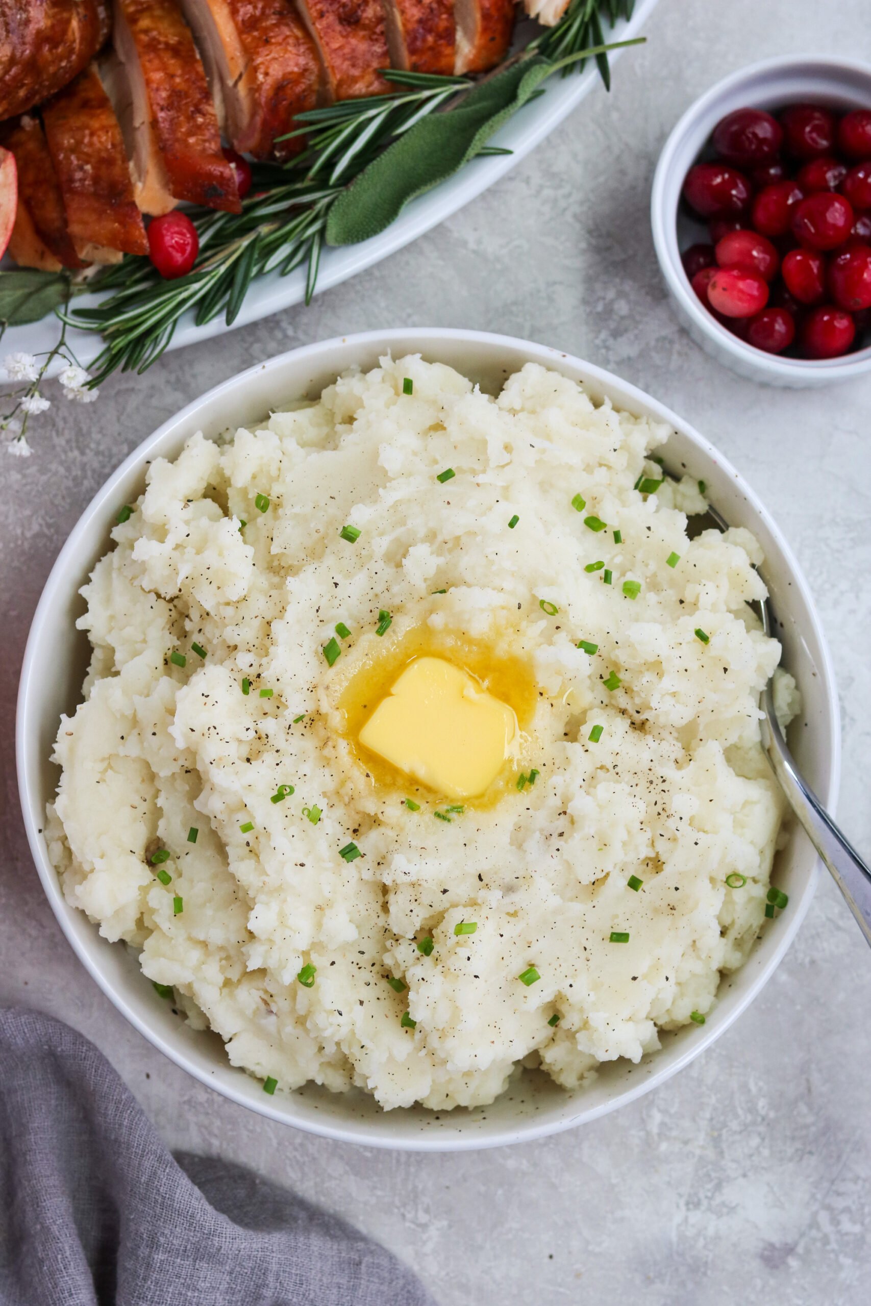 Whole30 mashed potatoes with vegan butter and chives in a white bowl