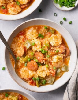 Instant Pot Jambalaya Soup in a bowl with a spoon topped with green onions