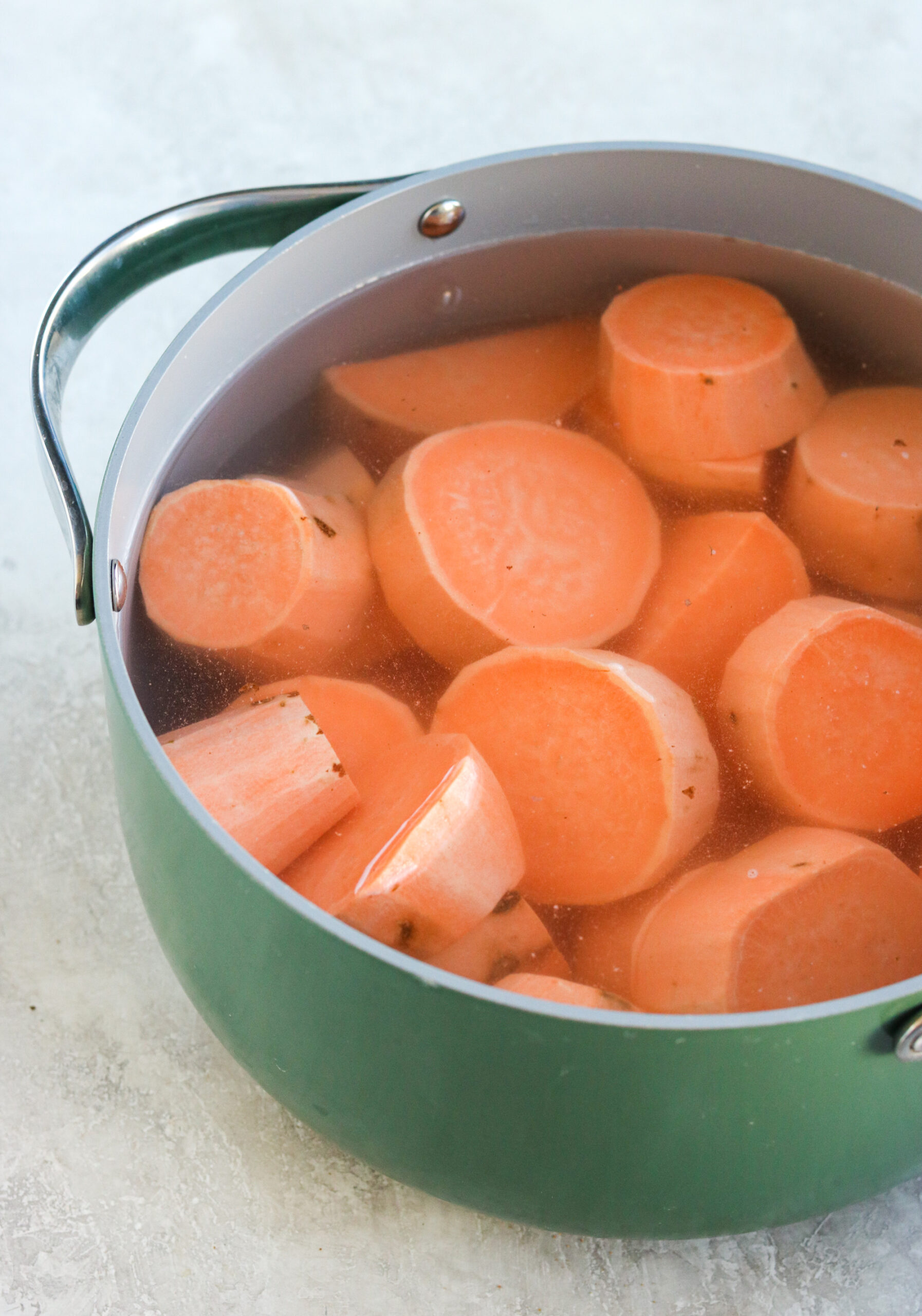 sweet potatoes peeled and cut and boiling in water