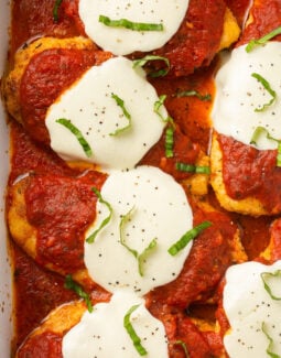 gluten free chicken parmesan in a casserole dish topped with basil
