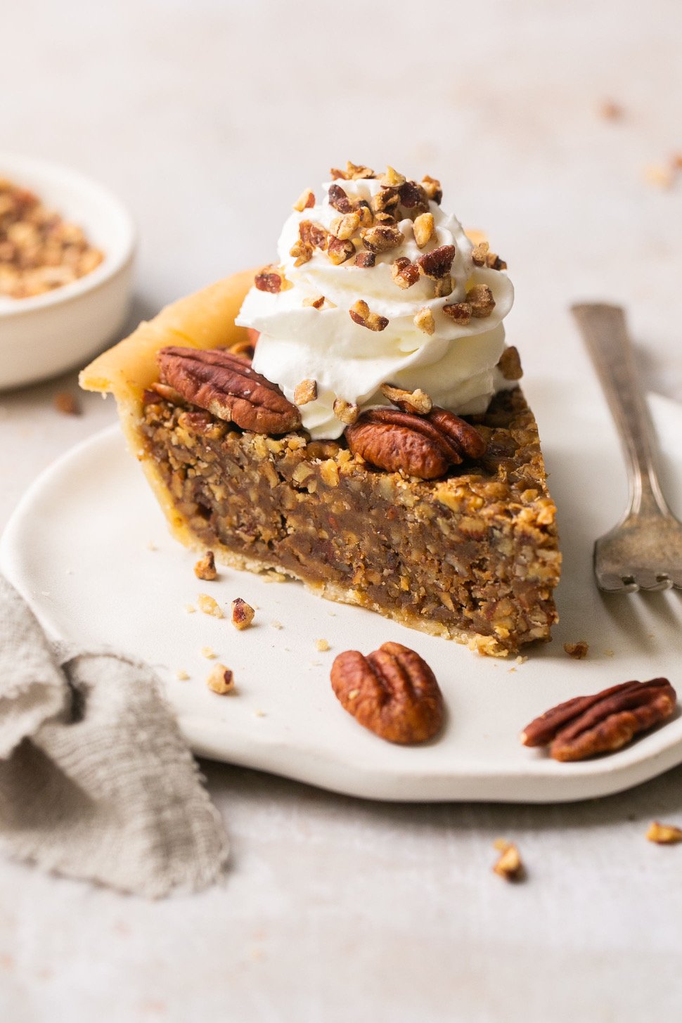 a slice of pecan pie topped with whipped cream
