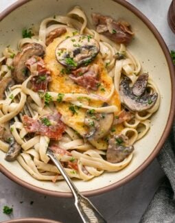 chicken marsala fettuccine in a bowl with a fork