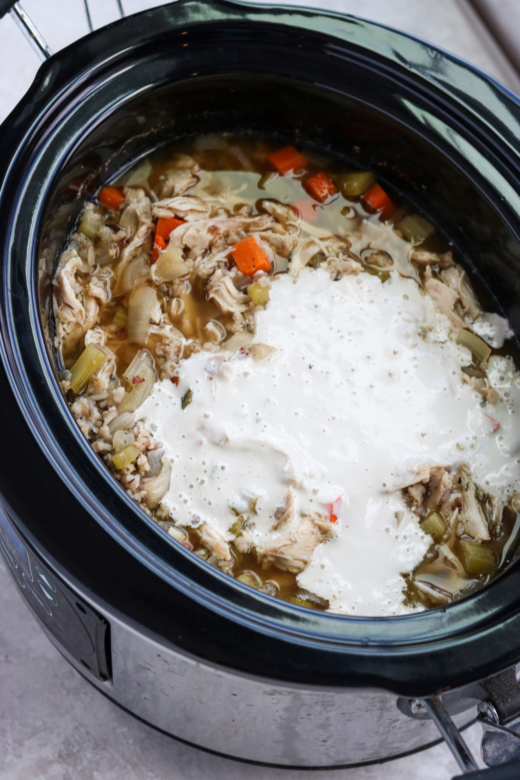 Cashew cream poured into chicken and wild rice soup