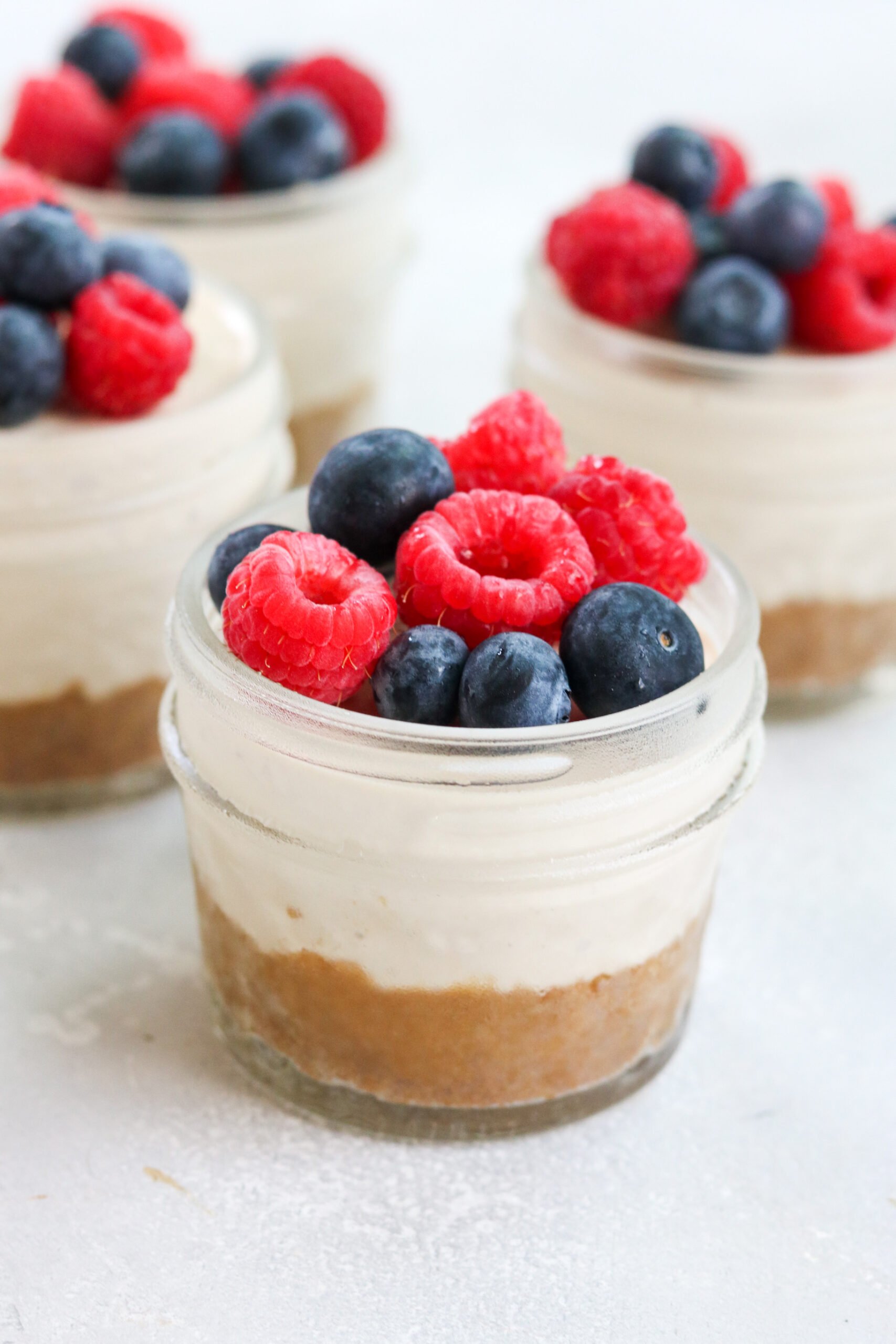 dairy free Mini Cheesecake Jars with berries on top