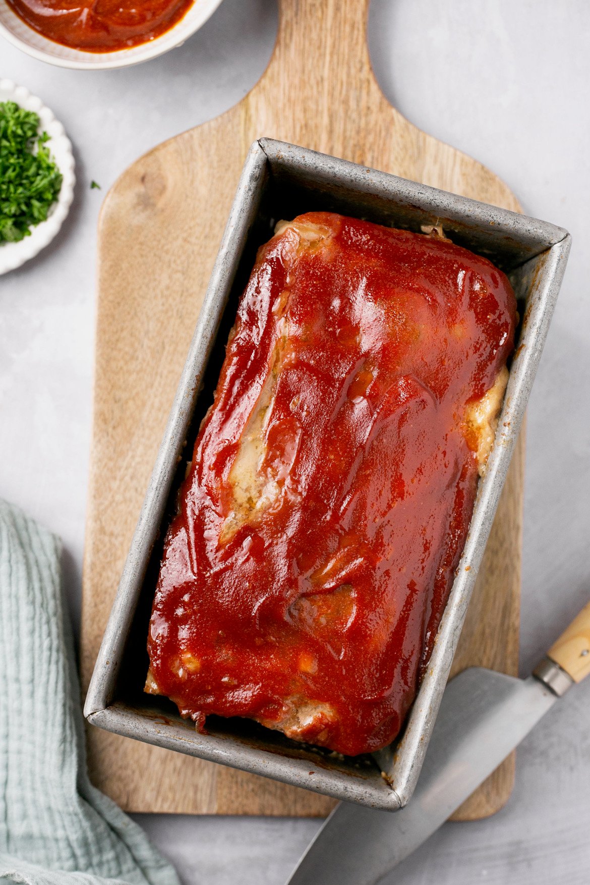 an overhead shot of a meatloaf glazed in a baking pan