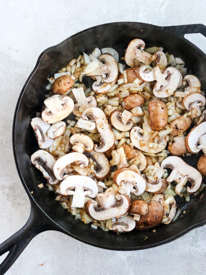 mushroom and onions sauteed in a skillet