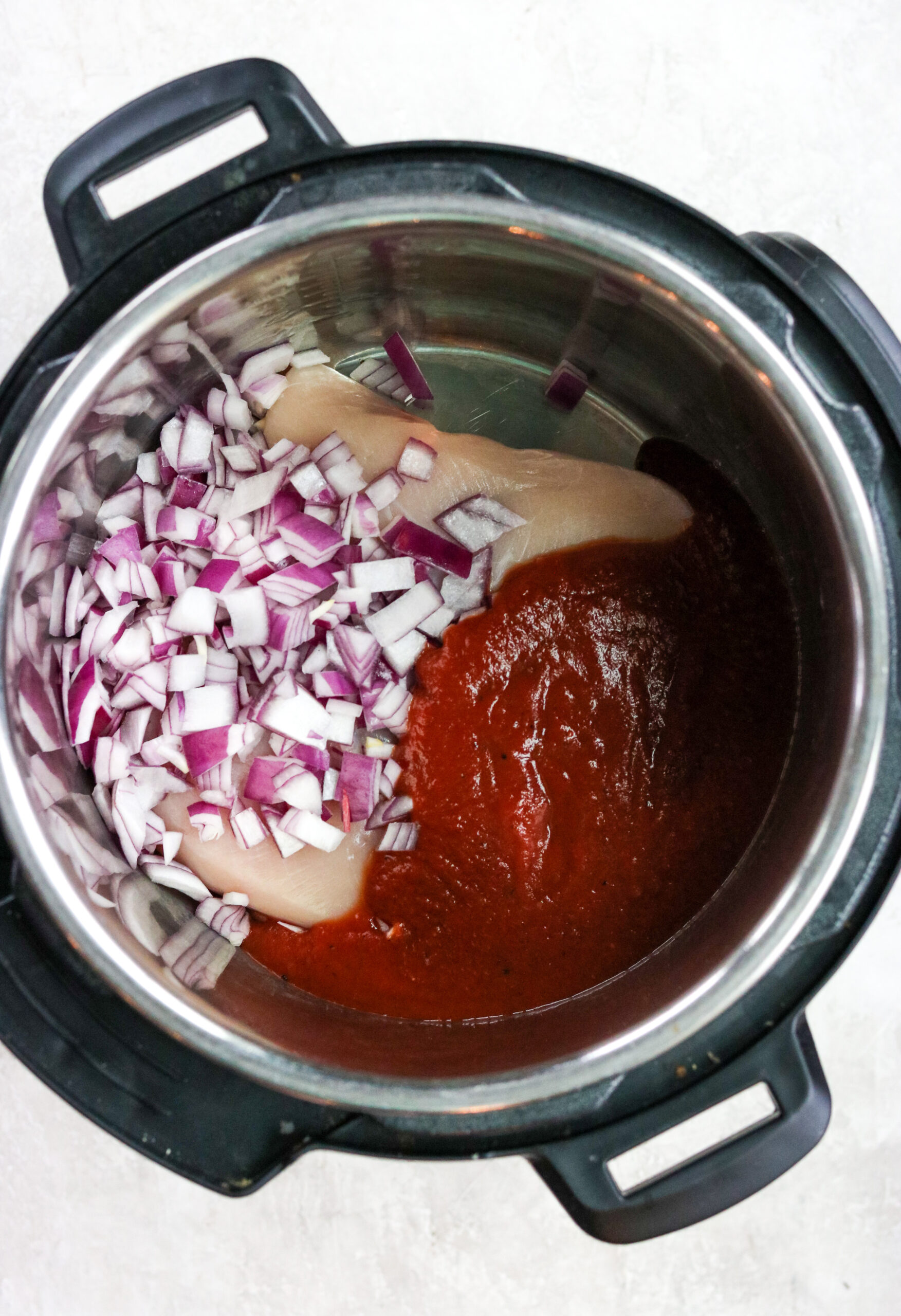 red onions, whole30 bbq sauce, and skinless boneless chicken breasts in an instant pot