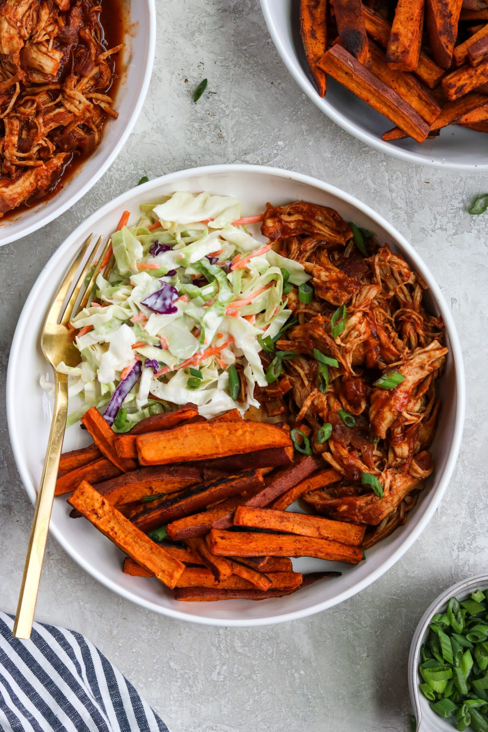 Instant Pot BBQ Chicken bowls with healthy cabbage recipe and homemade sweet potato fries in a white bowl with a gold fork