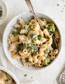 One Pot Gluten Free Broccoli Mac and Cheese in a bowl with parmesan cheese and a spoon