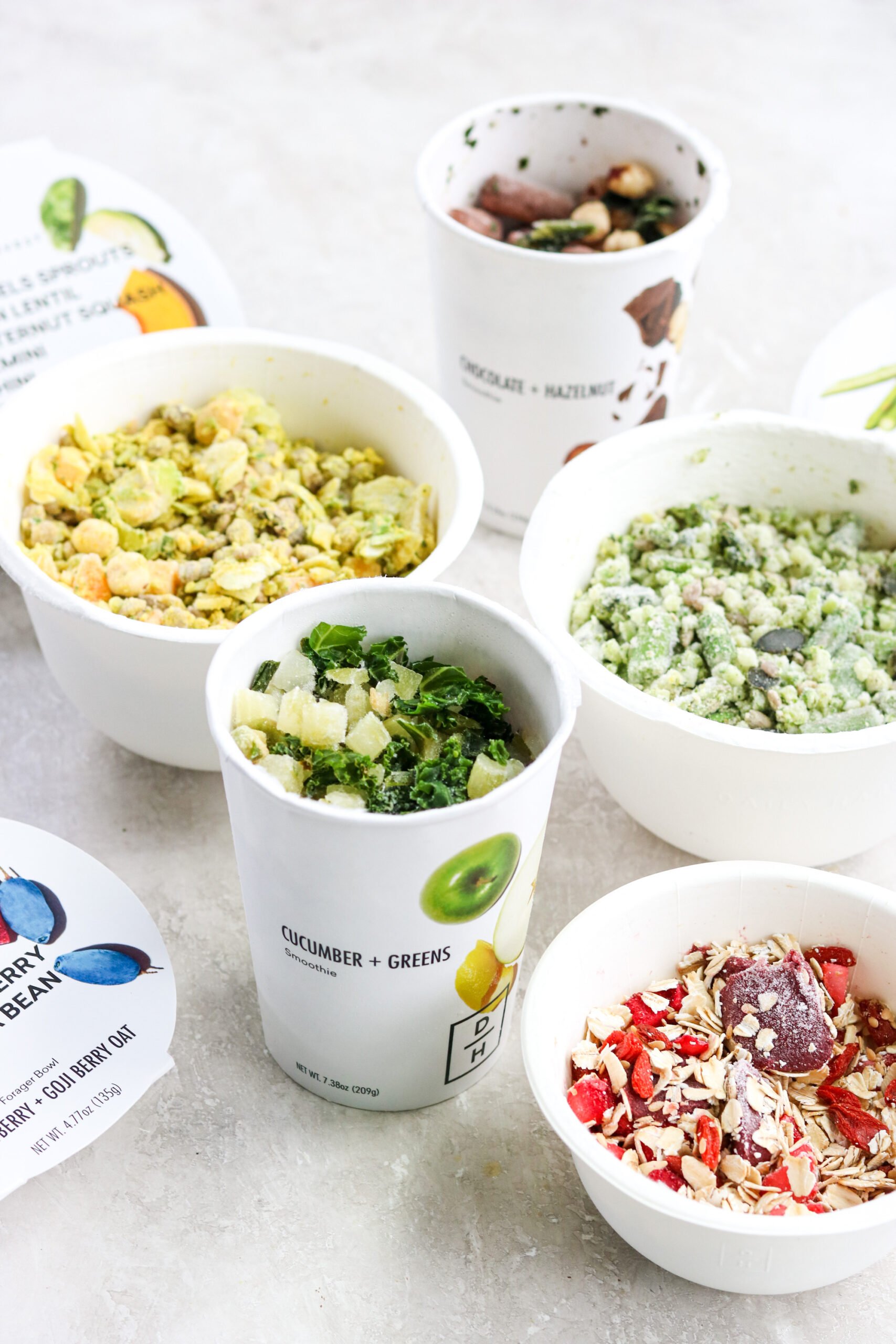 Daily harvest smoothies and harvest bowls with the lids off, still frozen