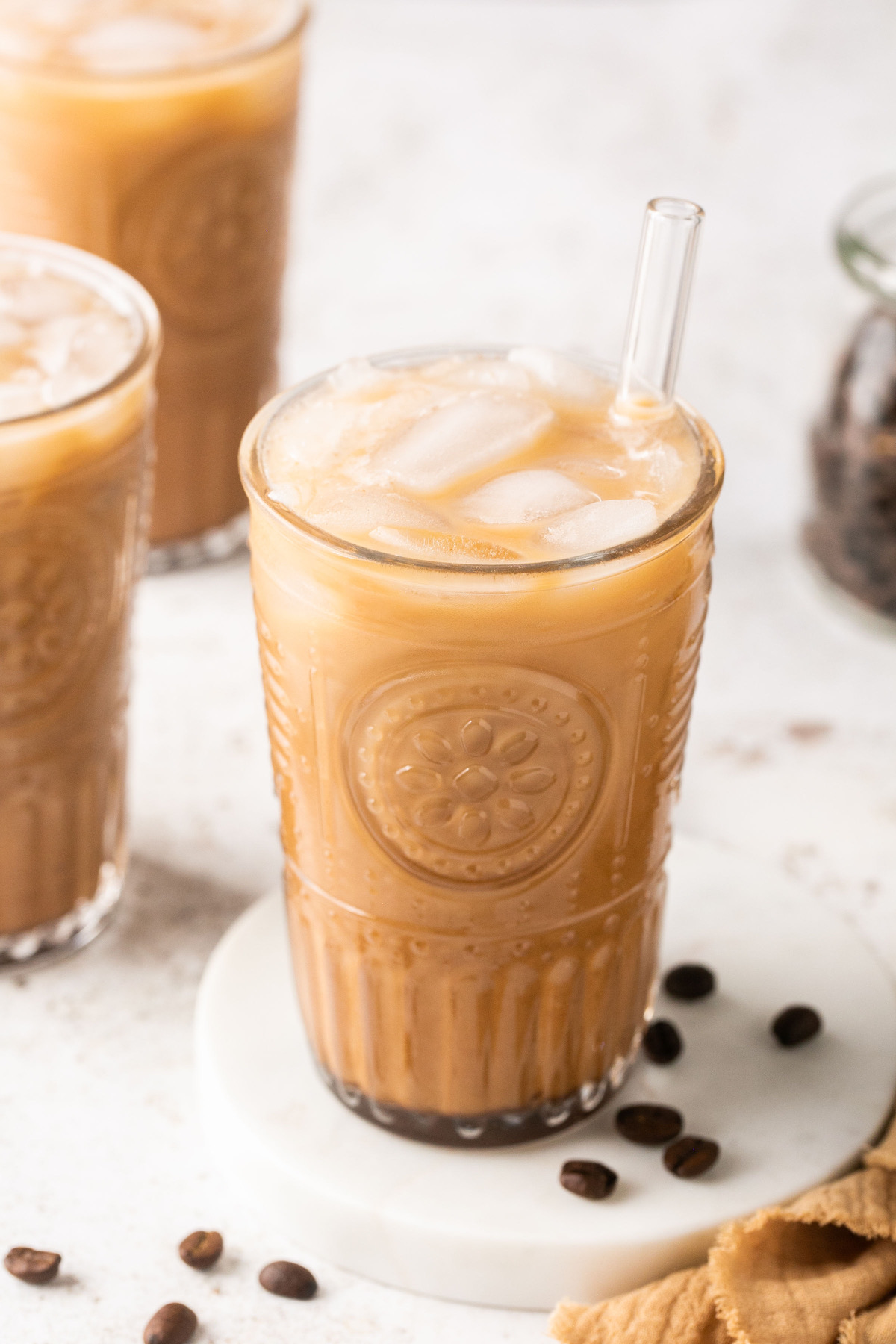 iced coffee in a glass with ice and a straw