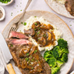 Instant Pot Steak with homemade gluten free gravy on a plate with mashed potatoes and broccoli