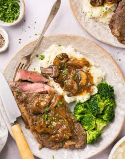Instant Pot Steak with homemade gluten free gravy on a plate with mashed potatoes and broccoli