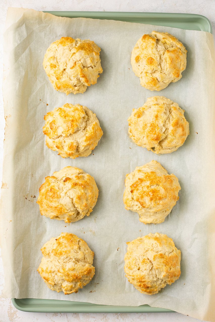 8 biscuits on a baking sheet with parchment paper