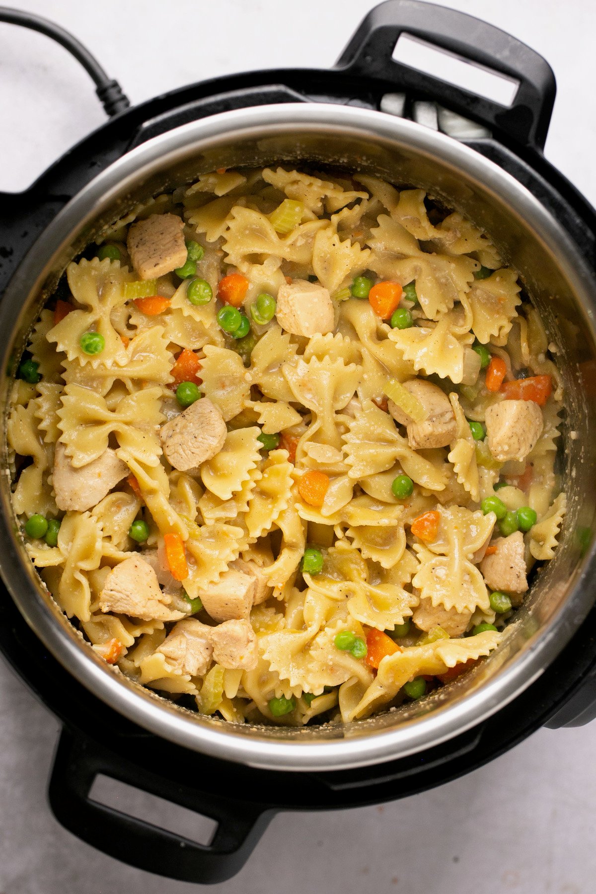 chicken and noodles in the instant pot with pea and carrots.