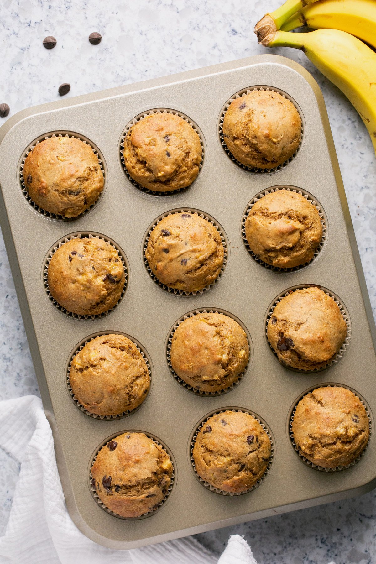 and overhead shot of baked banana protein muffins in a muffin tin