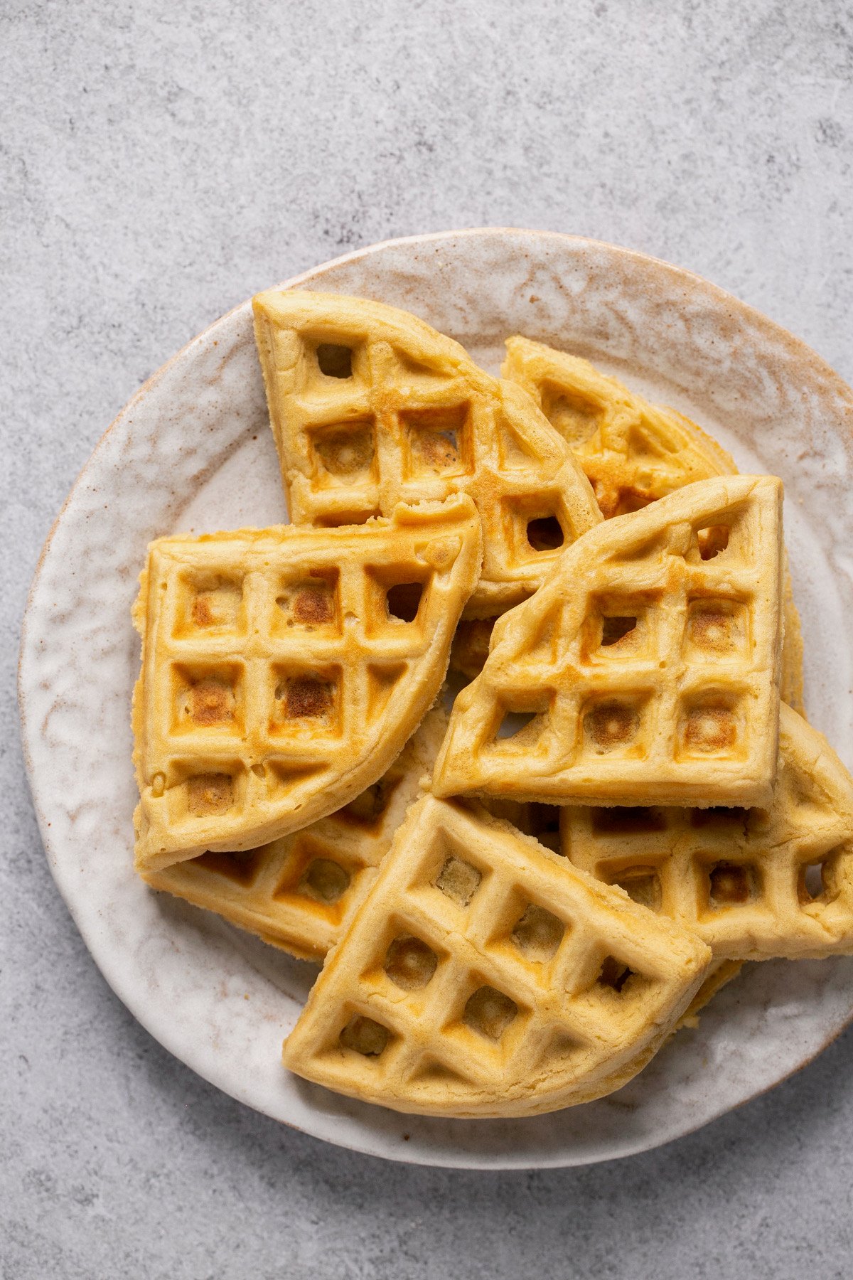 waffle triangles stacked on a white plate