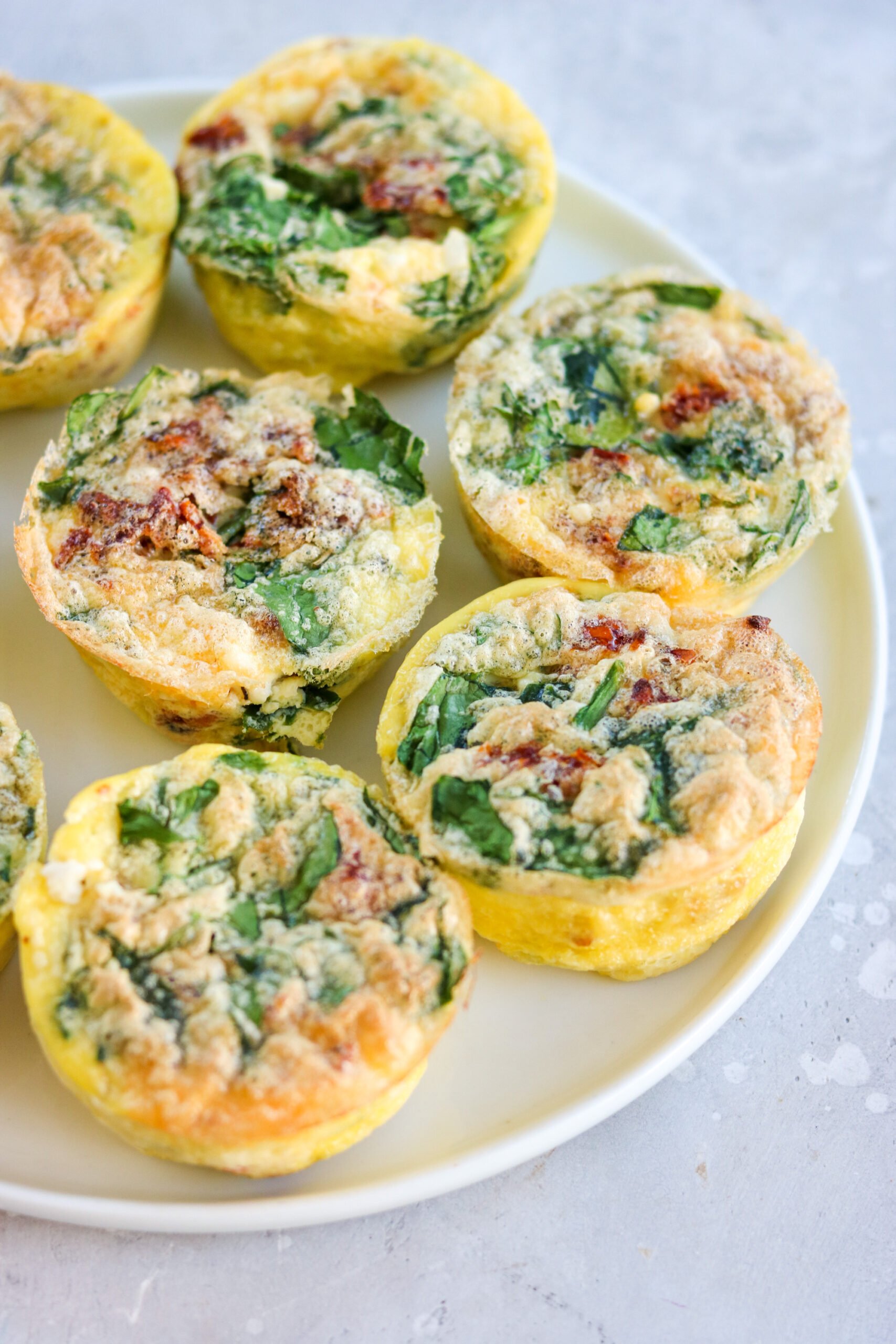 spinach feta egg muffins on a round white plate