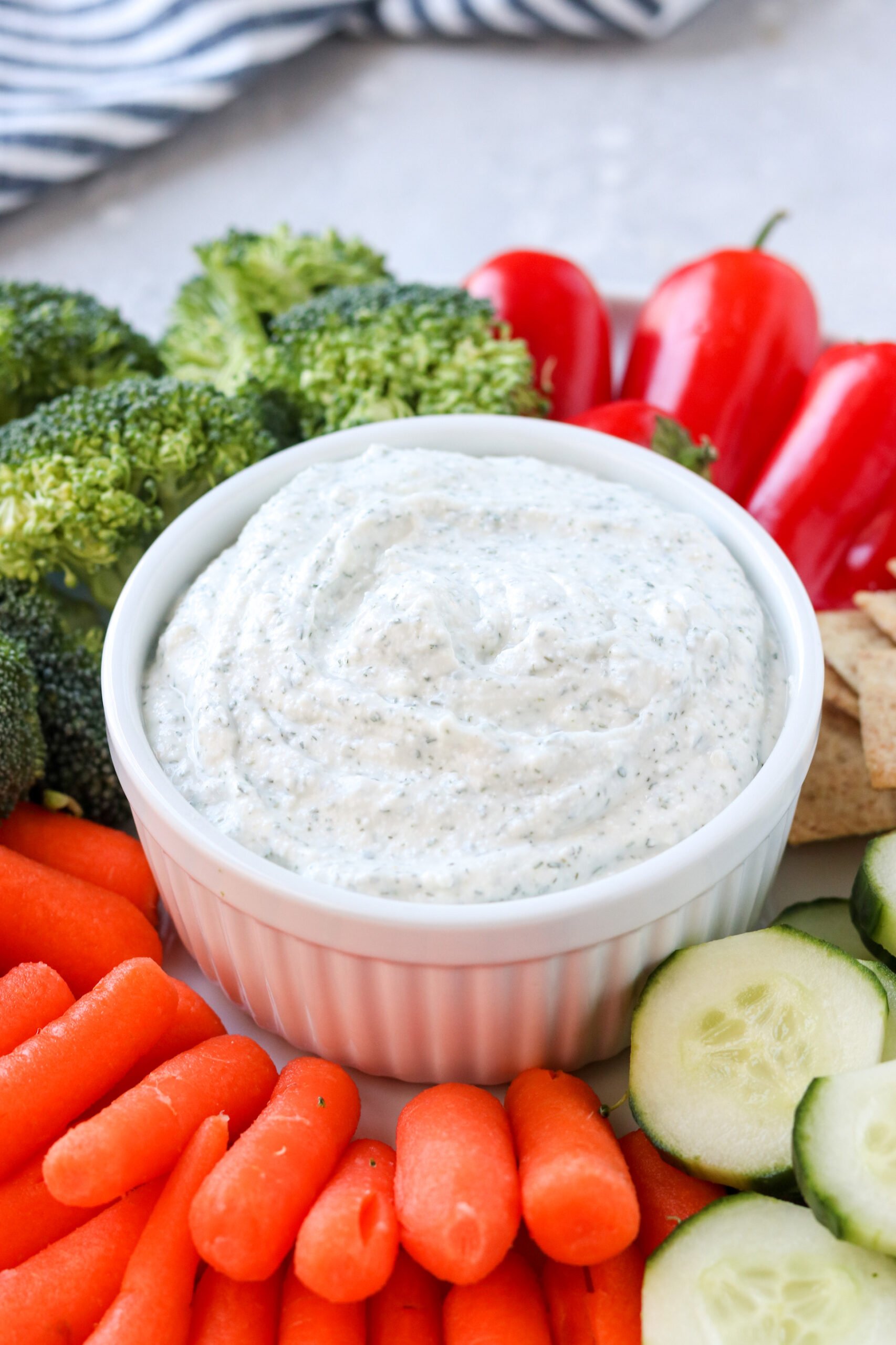 an up close photo of ranch dip in a white bowl. 