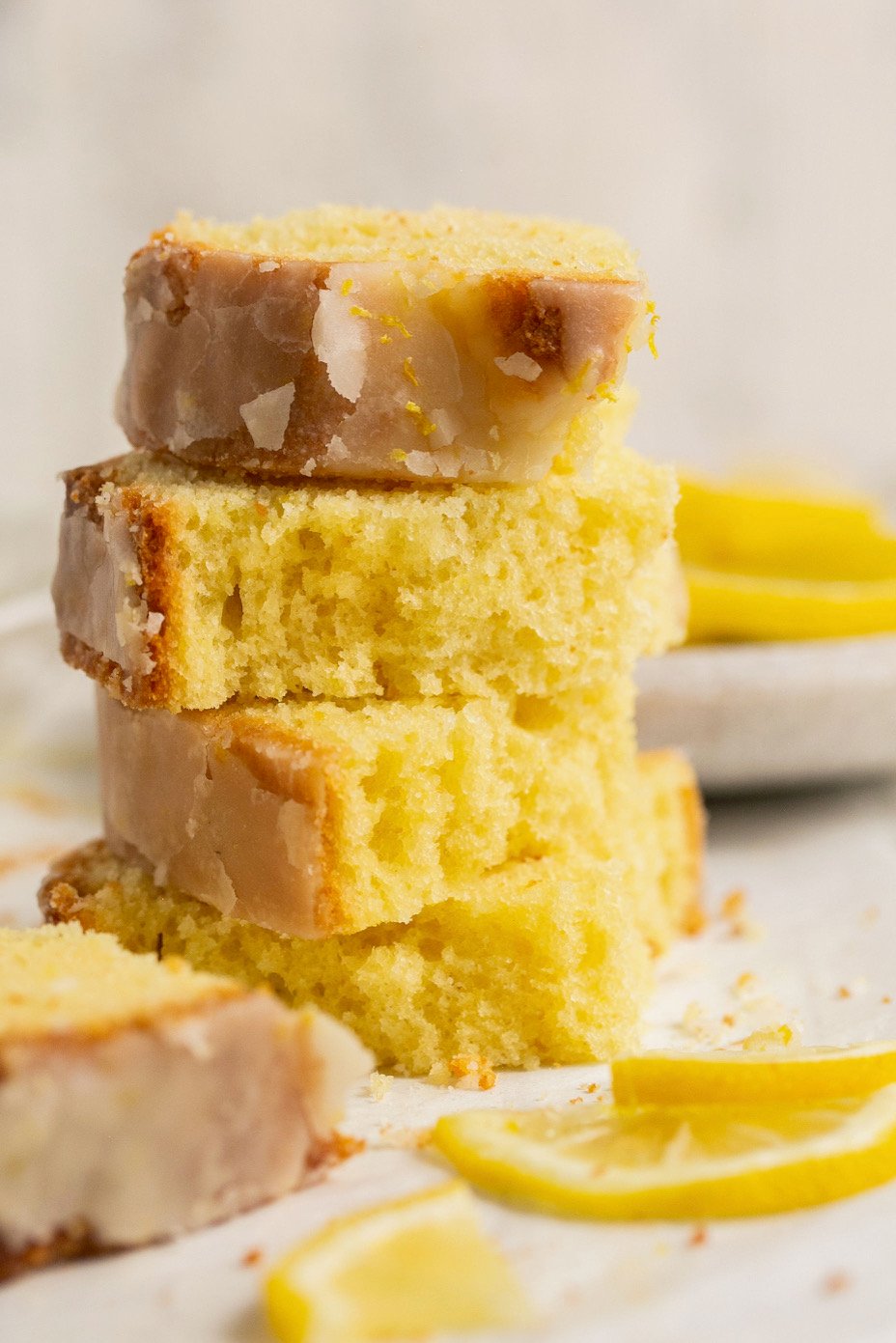 4 pieces of lemon drizzle cake stacked on top of each other