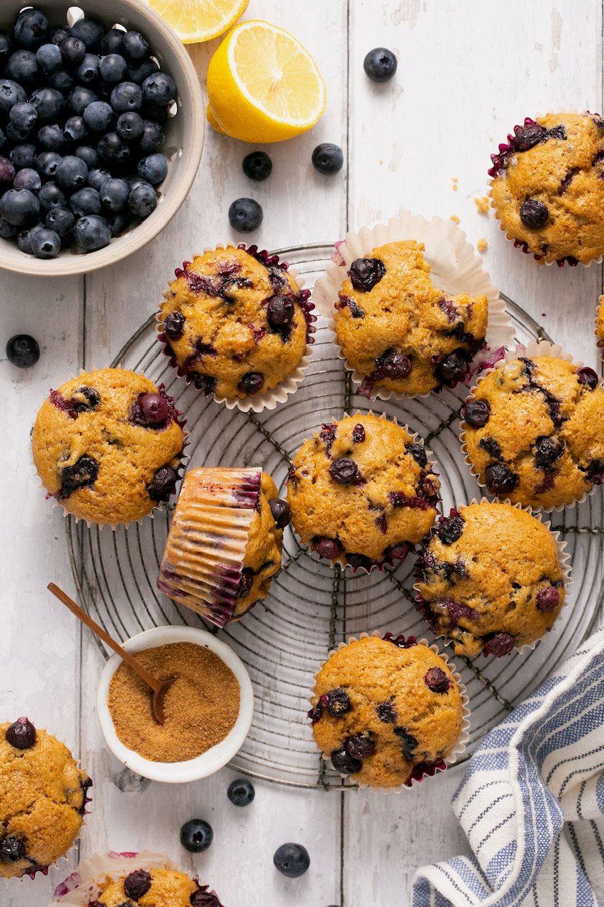 an overhead shot of gluten free blueberry muffins on a wire rack. 