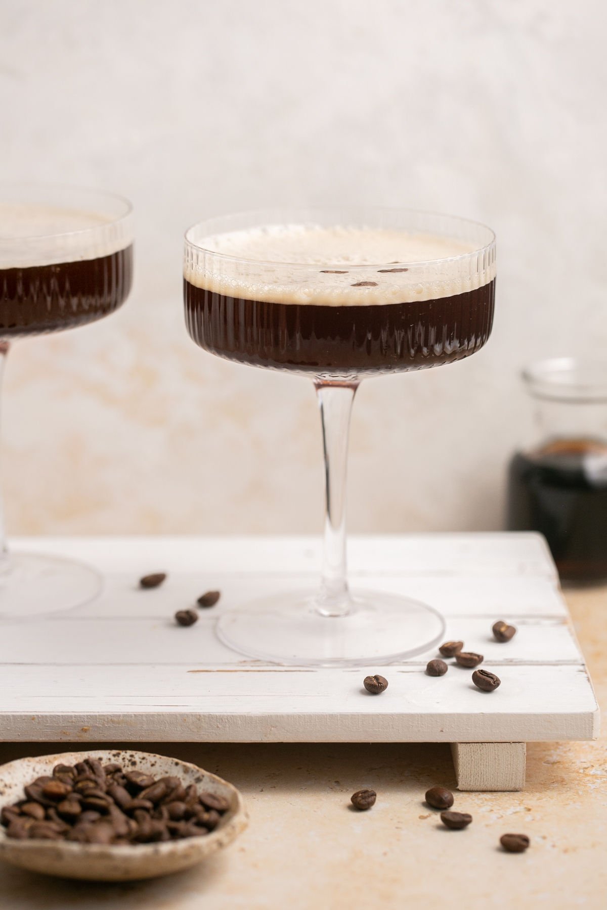 two kahlua martinis on a palate with coffee beans