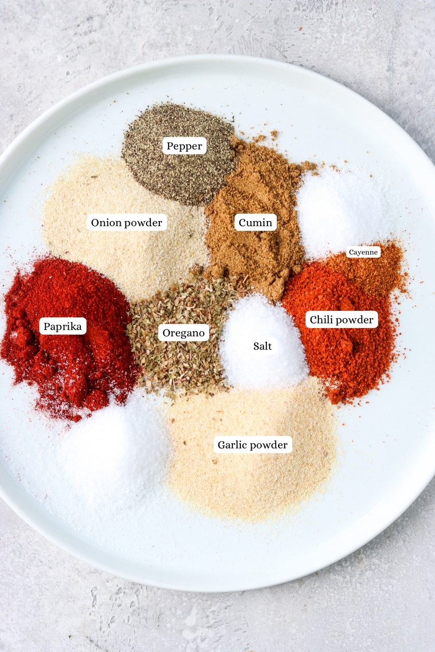 taco seasoning spices on a white plate with labels 