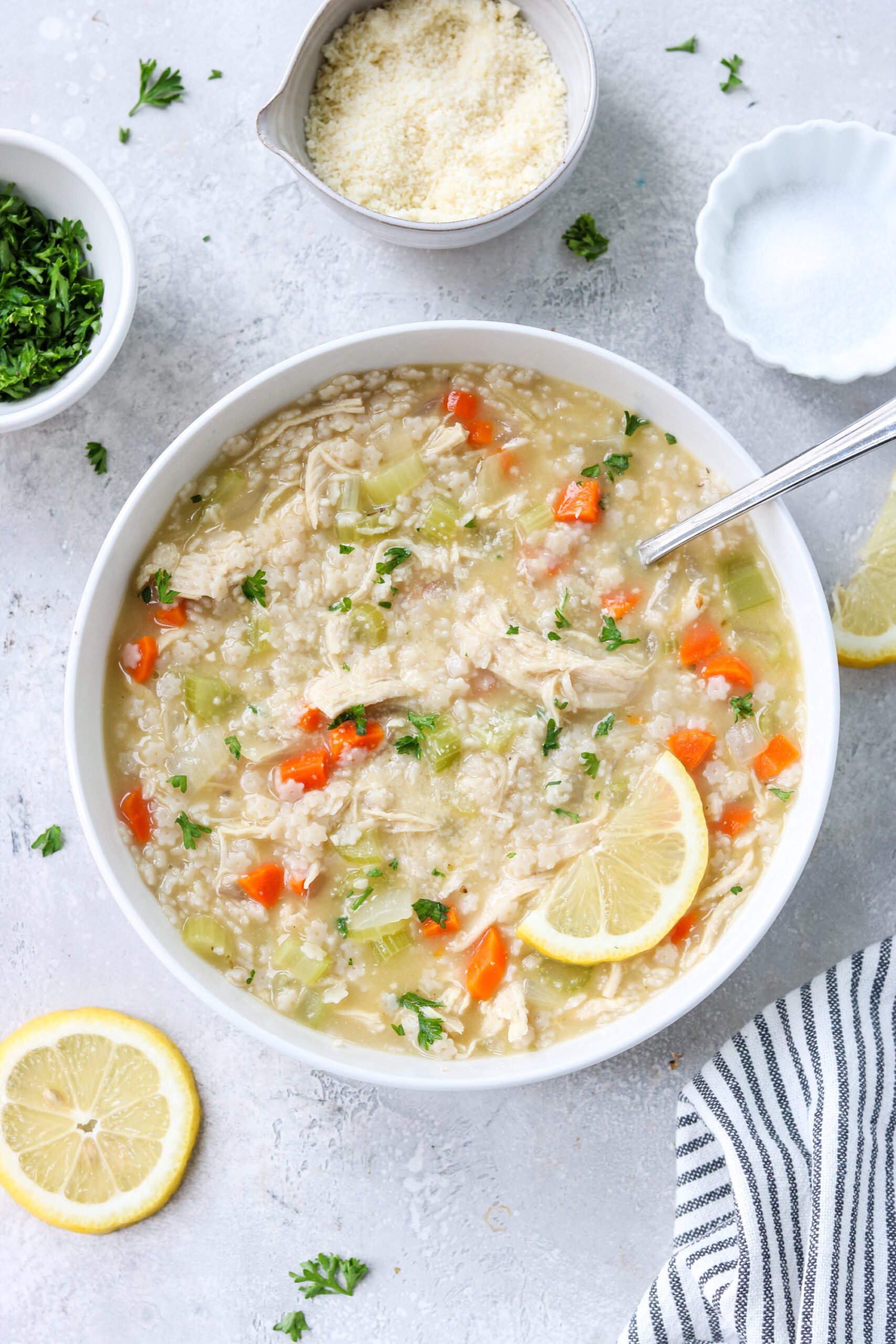 gluten free chicken pastina soup in a bowl topped with parsley