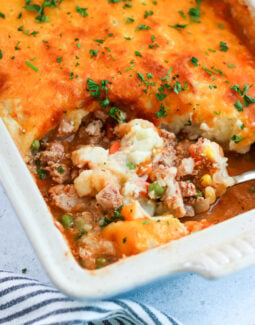 ground turkey shepherd's pie in a casserole dish with a scoop being taken out