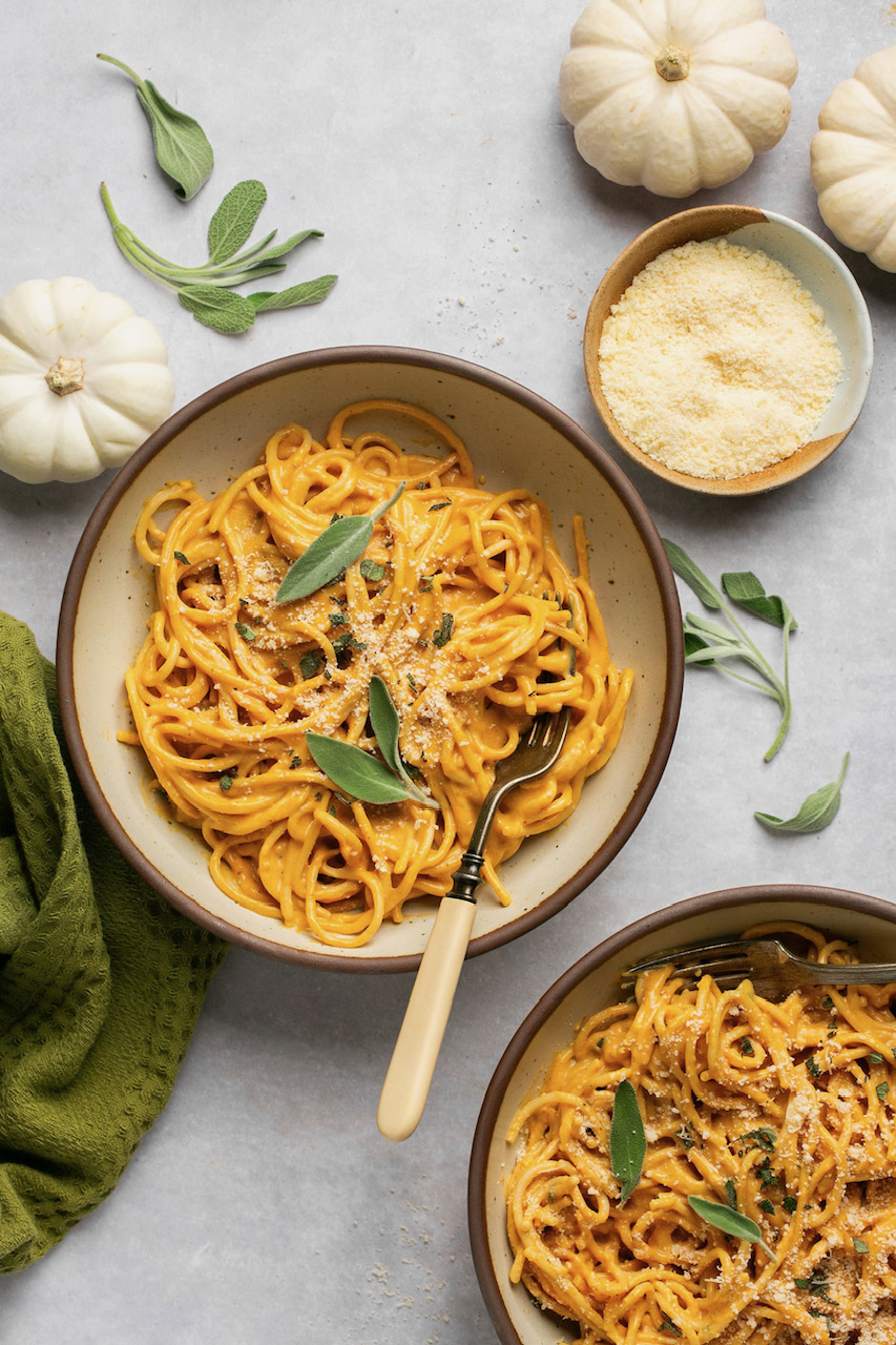 pumpkin pasta in 2 bowls topped with sage