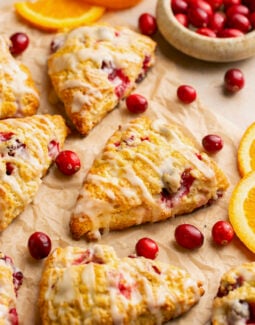 gluten free scones with orange and cranberry on a piece of parchment paper
