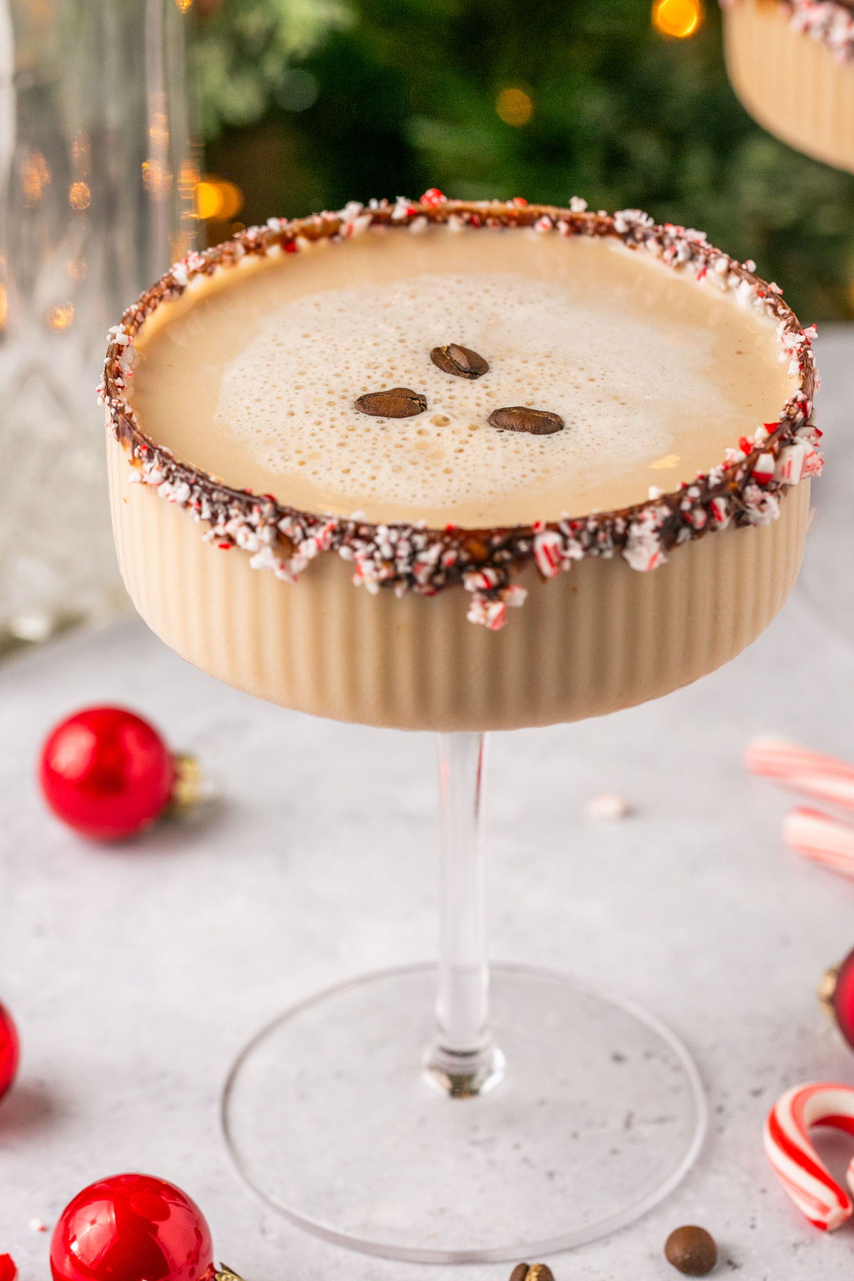 a closeup of an espresso martini with 3 coffee beans