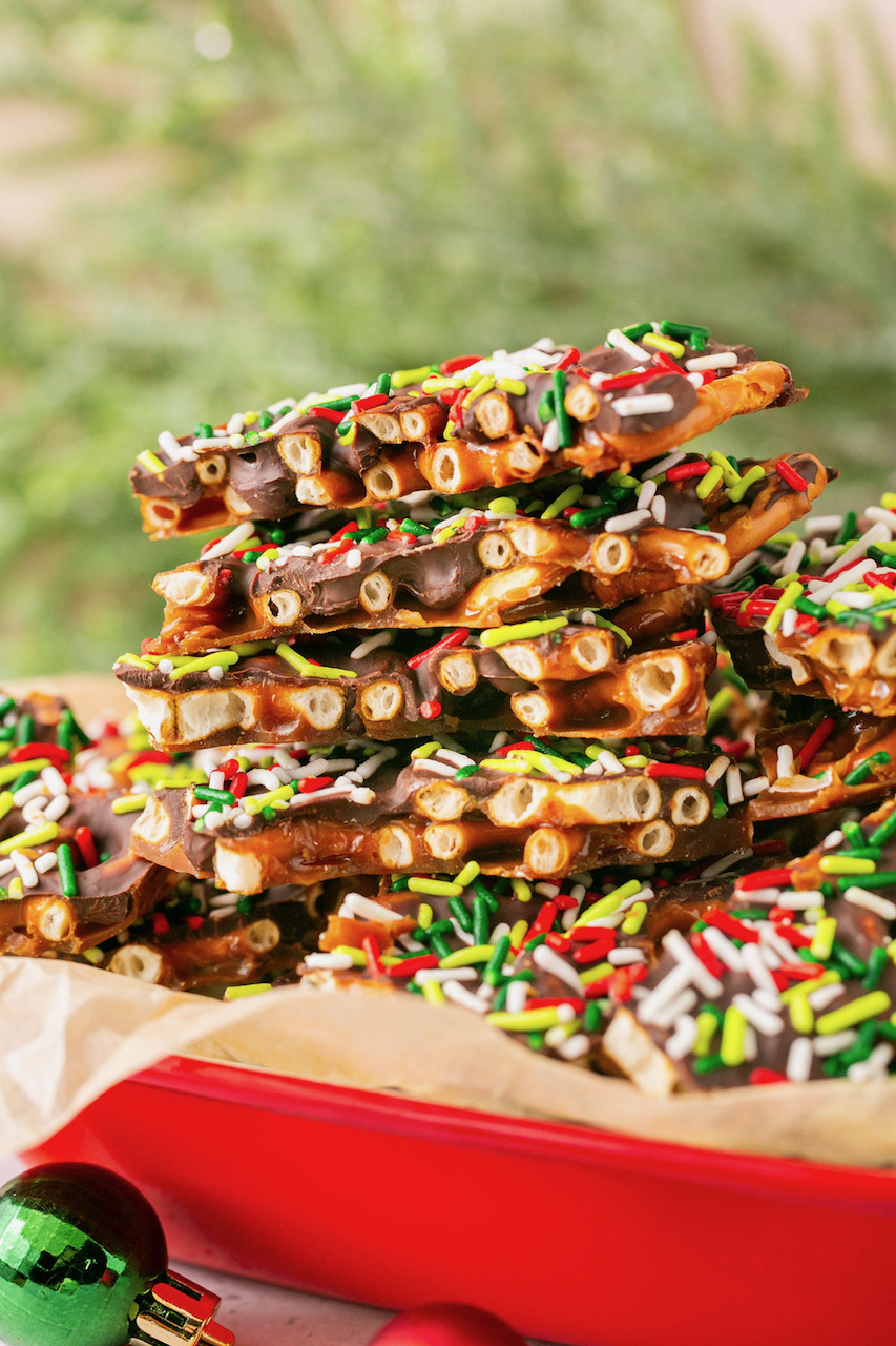 Gluten free pretzel Christmas crack stacked up on parchment paper