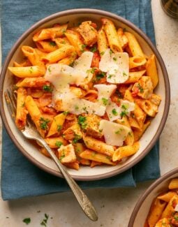chicken and penne vodka in a bowl topped with parmesan and parsley
