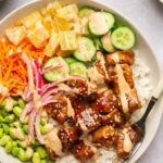 chicken poke bowls with toppings and spicy mayo in a bowl