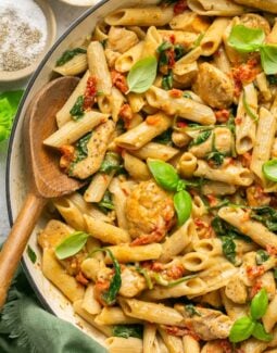 Marry me chicken pasta in a skillet with a wooden spoon