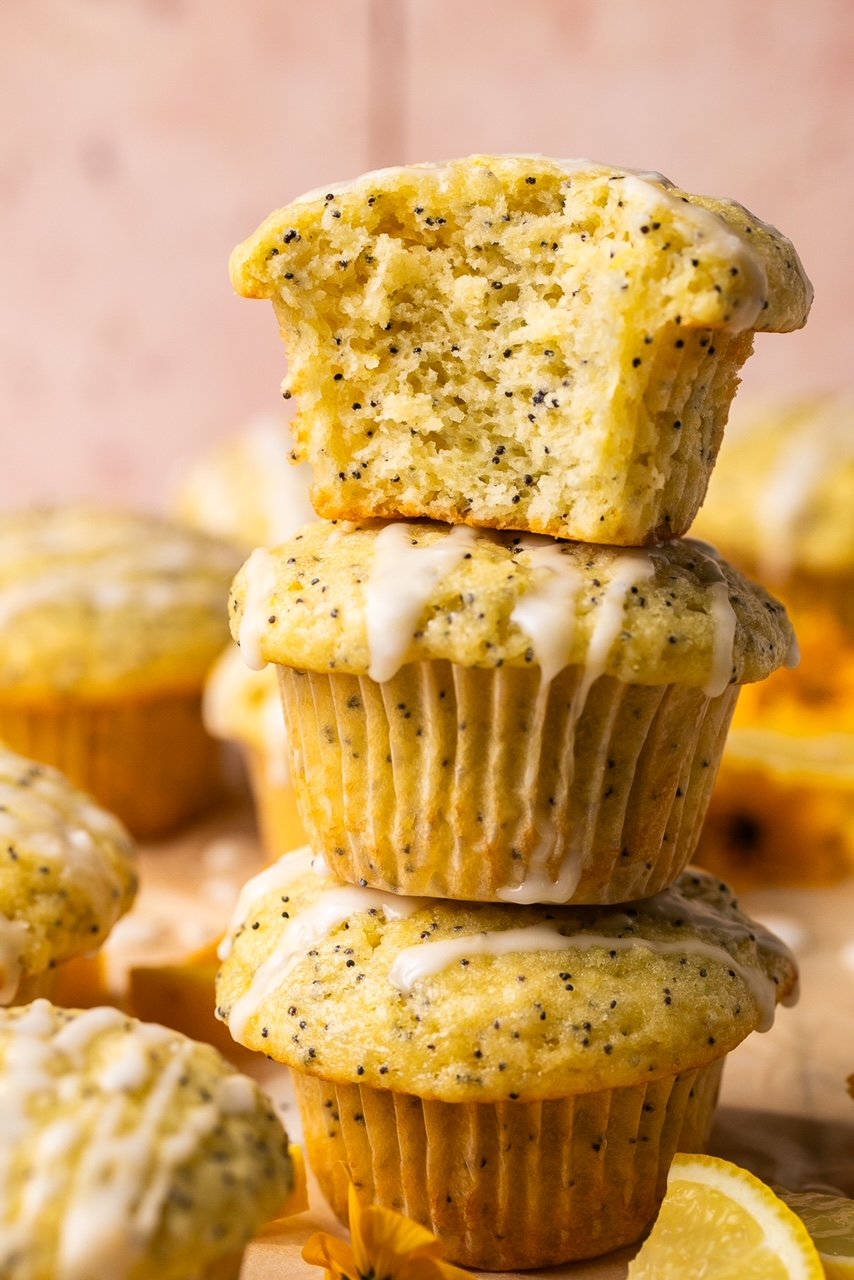 lemon poppyseed muffins stacked on top of each other with a bite taken out of one