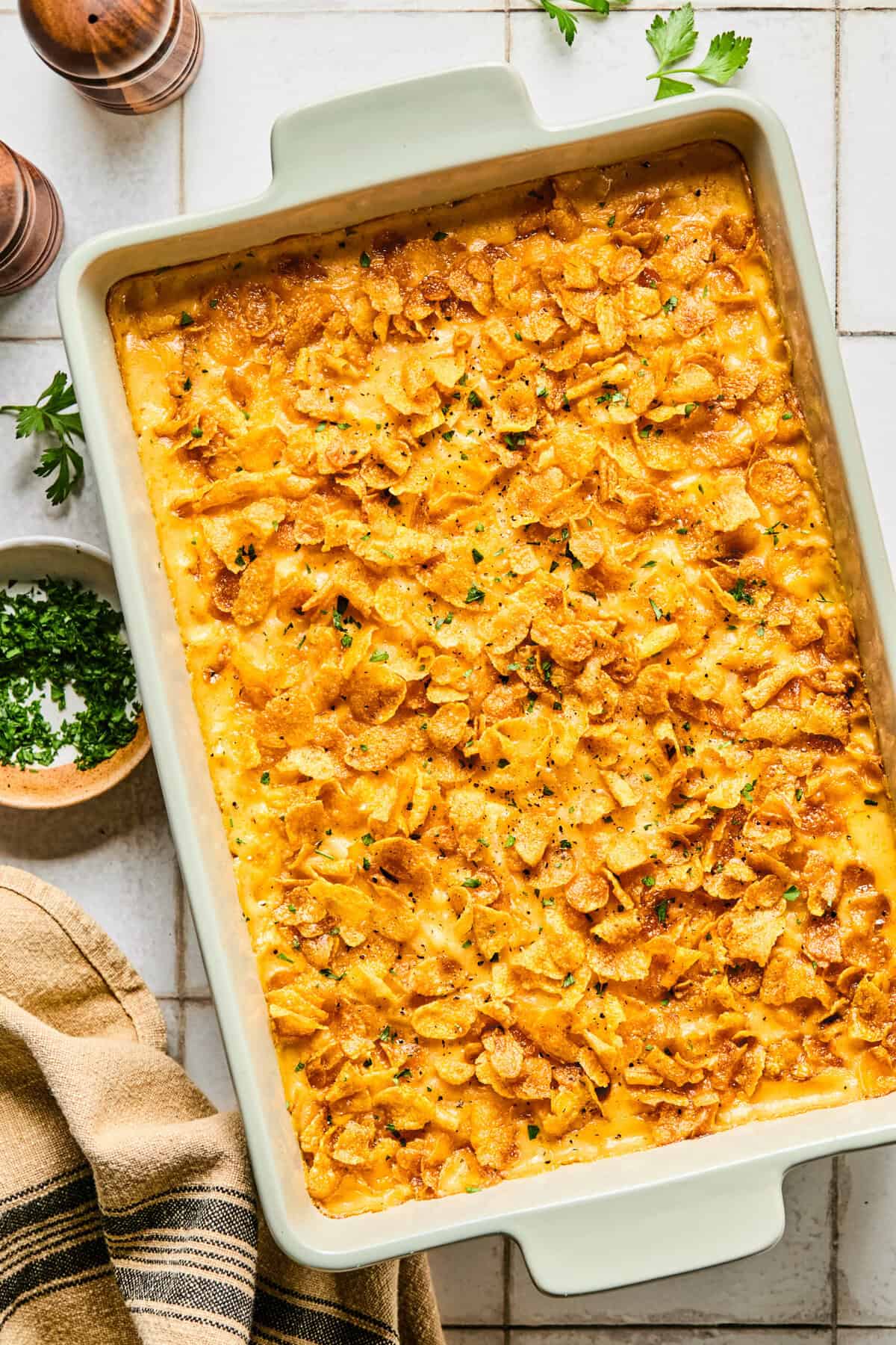 Cheesy hashbrown casserole in a large white baking dish.