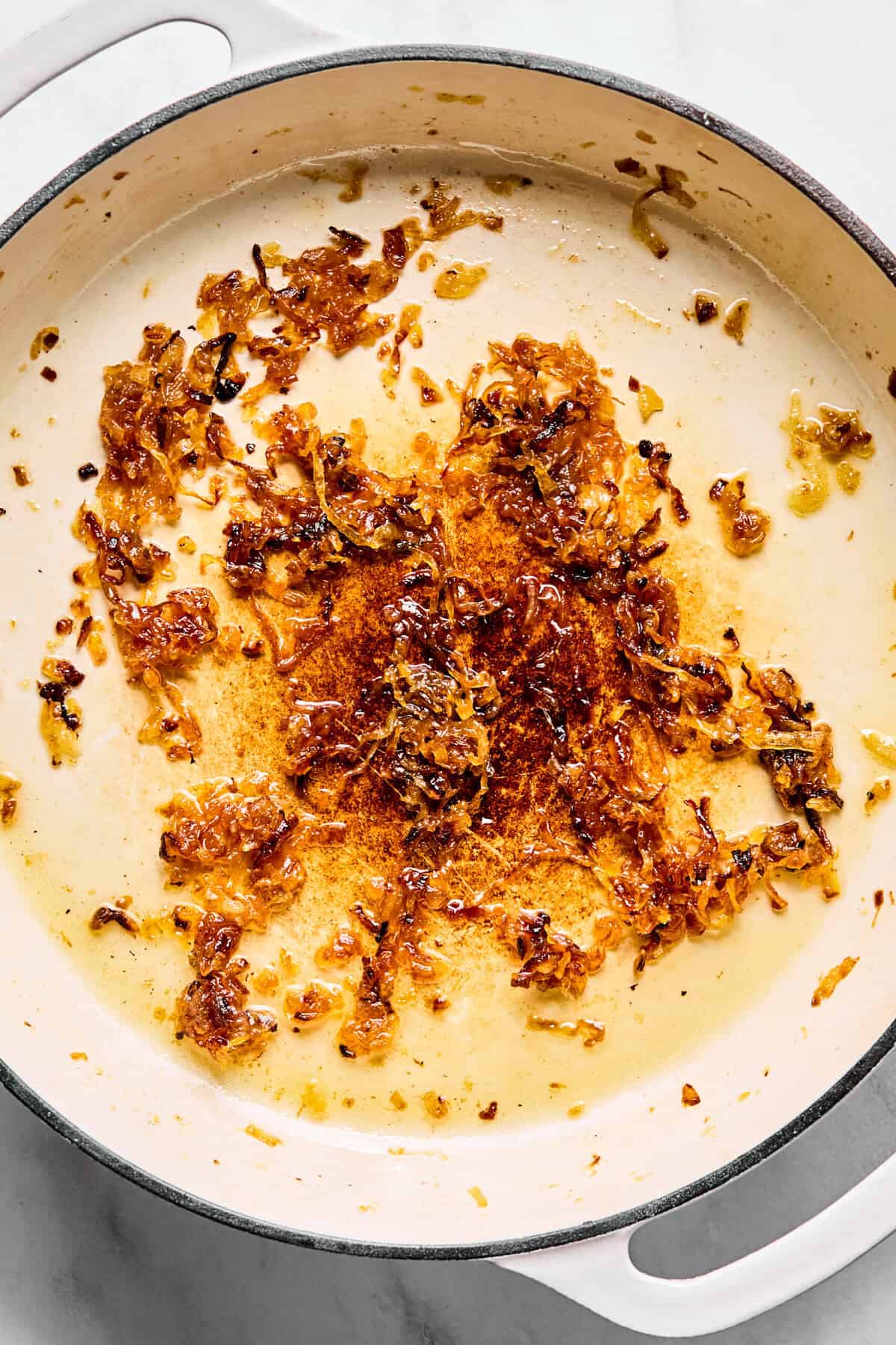 Large oven-safe skillet with caramelized onions.