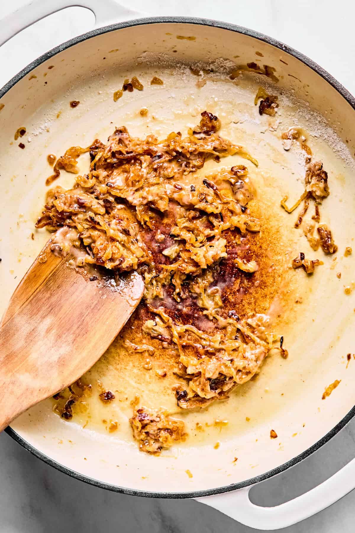 Caramelized onions coated in gluten-free flour in large oven-safe skillet.