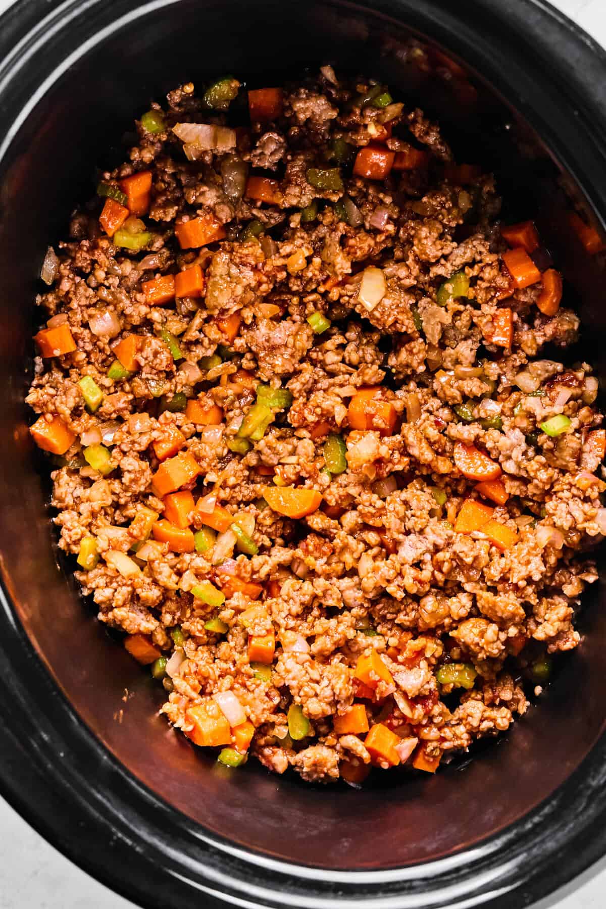 sausage tortellini soup ingredients placed in the slow cooker
